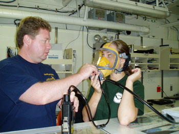The maritime heritage team dons agamasks in the dry lab to get practice in using their new underwater communication system. Photo: Claire Johnson/NOAA